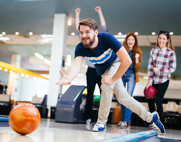 Man Bowling with Friends